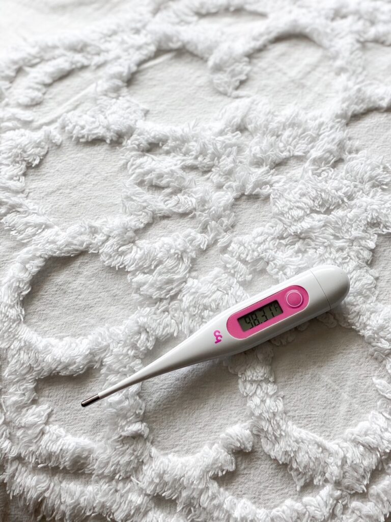 basal body thermometer on white backdrop