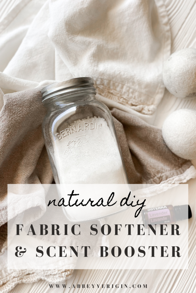 mason jar of fabric softener on white wood backdrop with crochet dish towels and dryer balls