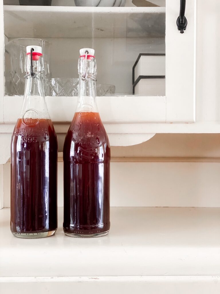 two large flip top bottles filled with kombucha
