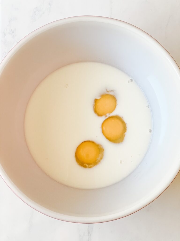 milk honey and eggs in a large red pyrex bowl