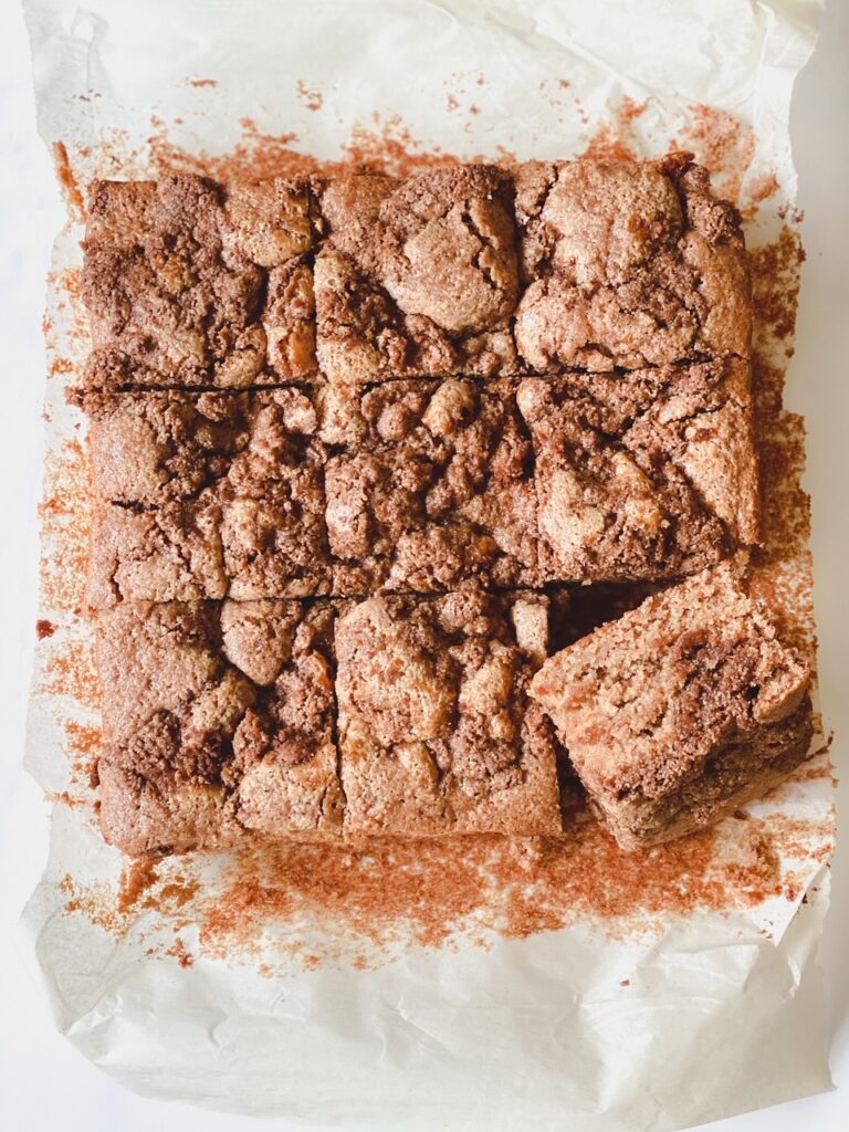 sliced cinnamon coffee cake on a piece of parchment paper
