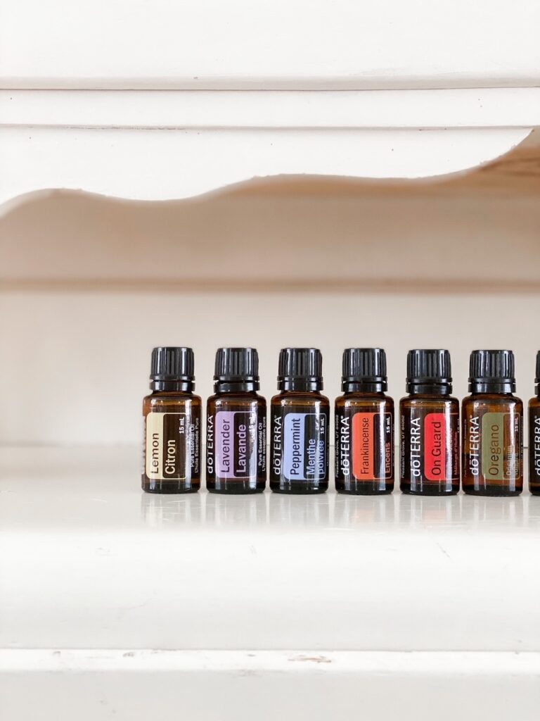doterra essential oils lined up on a cream colored hutch